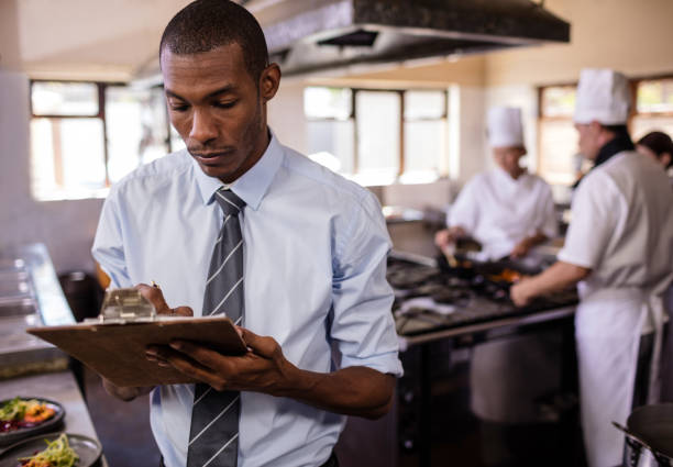istock Male manager writing on a clipbaord in kitchen 1094922512