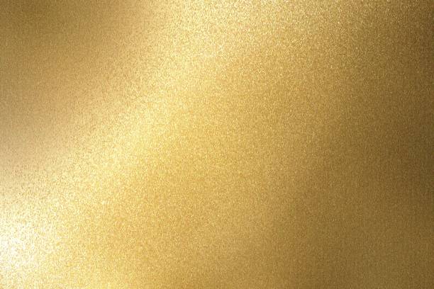 istock Abstract background, light shining on rough gold metallic wall texture 1094922838