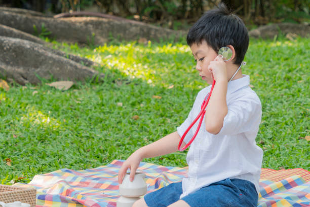 istock boy use stethoscopes and feel happy in garden park 1094924546