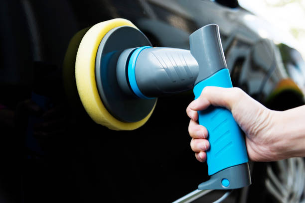 istock Woman hand using hand held car polishing machine 1094924644