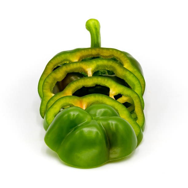 istock Green bell pepper slices isolated on white background. 1094930834