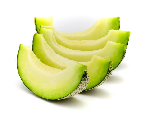 istock Green melon slices isolated on white background. 1094933162