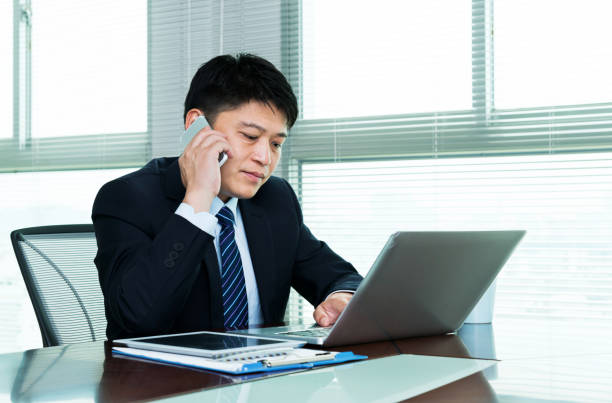 istock Businessman talking on mobile phone in office 1094938218