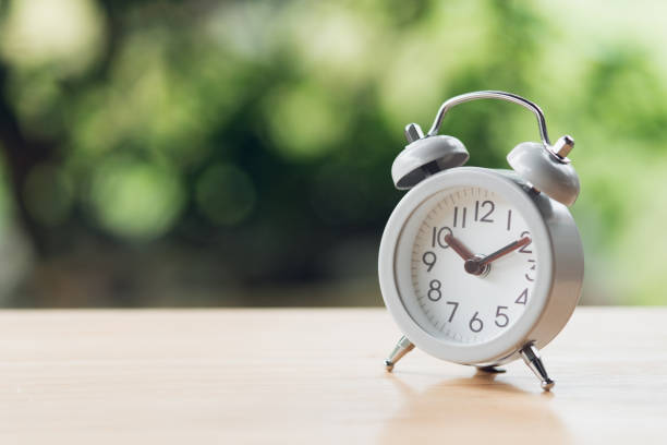 istock Vintage White Alarm Clock on wood. It's time to rest. using as background  Relaxing time concept with copy spaces for your 1094938808