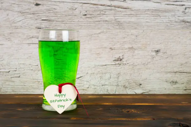 Happy St.Patrick's Day, green beer in glass with heart shape