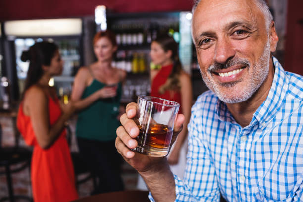 istock Man enjoying whiskey in night club 1094945404