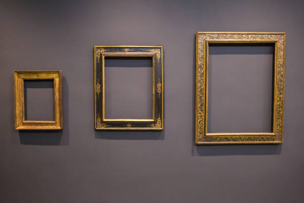 istock Set of vintage blank empty picture frames on grey wall 1094945888