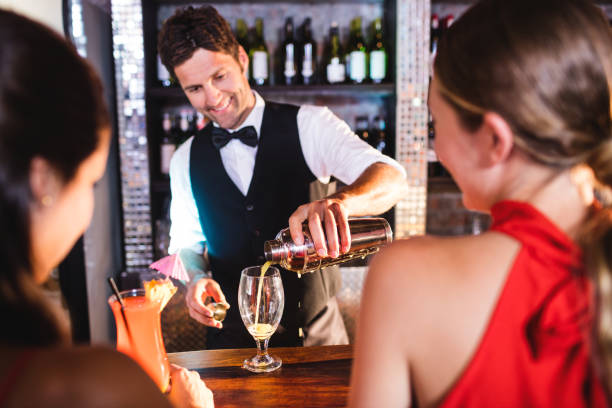 istock Bartender pouring cocktail in glass at bar counter 1094951524