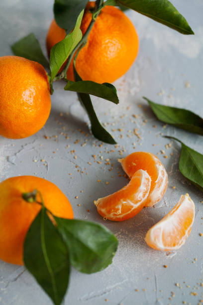 istock Fresh juicy orange tangerines on blue background close up. 1094952296