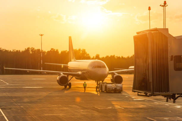 istock Passenger airplane during push back operation, evening airport at sunset 1094954304