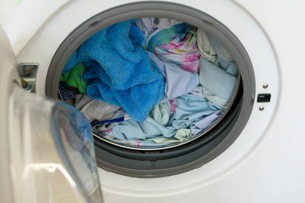 istock Washer. loaded laundry. filled drum washing machine. 1094957060