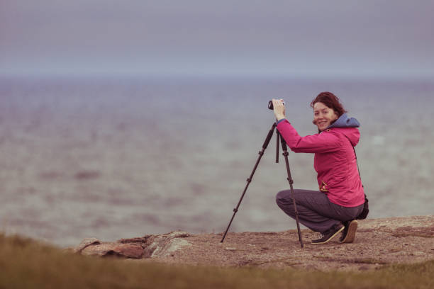 istock Tourist with camera on seashore, Norway 1094957244