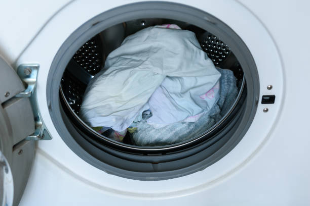 istock Washer. loaded laundry. filled drum washing machine. 1094957370