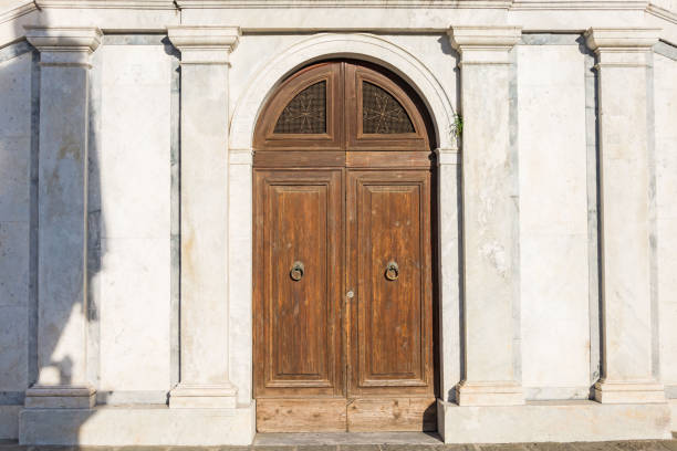 istock Double arched wooden doors with metal ring handles 1094961358