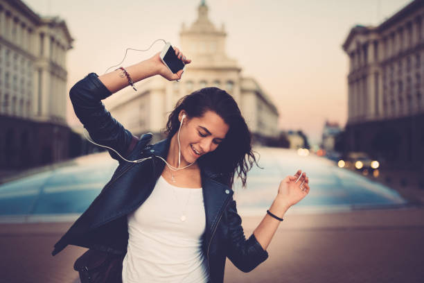 istock Young woman dancing on music 1094961840