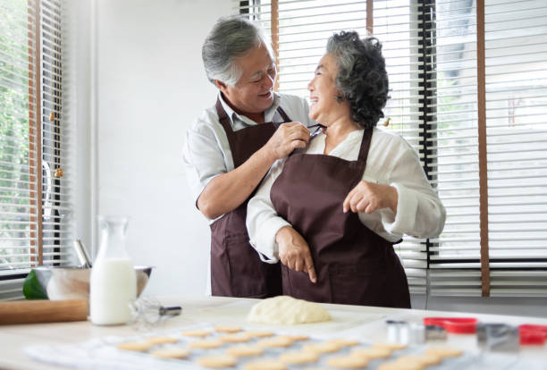 istock Smiling Husband is tying apron for his wife. 1094962120