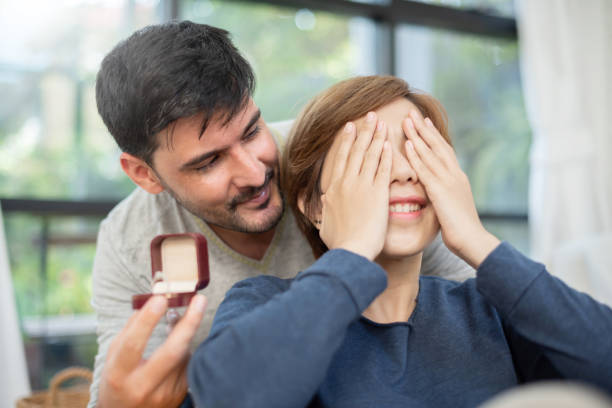 istock Young man surprising his beautiful girlfriend. 1094962138