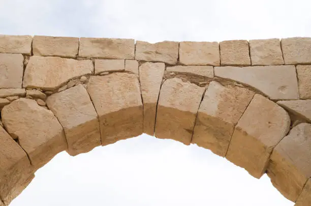 Ancient stone arch and keystone in the sky closeup