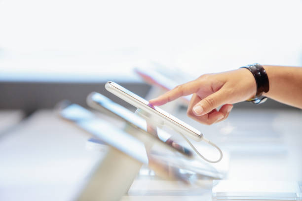 istock close up hand choosing a new mobile or smart phone in a shop 1094966414