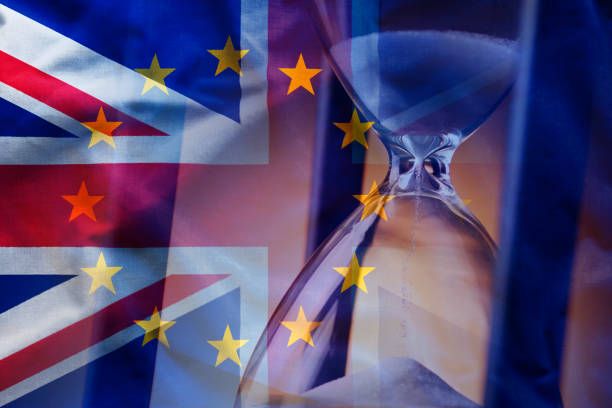 Sandglass near European and British flags Closeup elegant sandglass counting down time to Brexit on background of overlapped flags of Great Britain and European Union diplomacy photos stock pictures, royalty-free photos & images