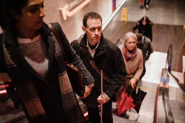 Visually Impaired Man Travelling on an Escalator