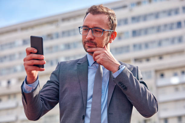 istock Businessman using his smartphone on the street. 1094971348