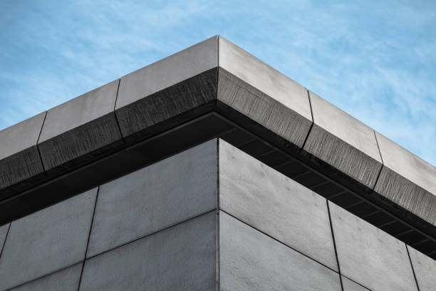 istock Corner of gray industrial building under blue sky 1094973776