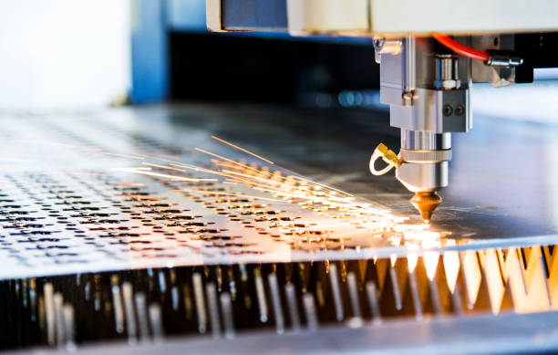 istock Laser cutting metal sheet with sparks flying 1094974012