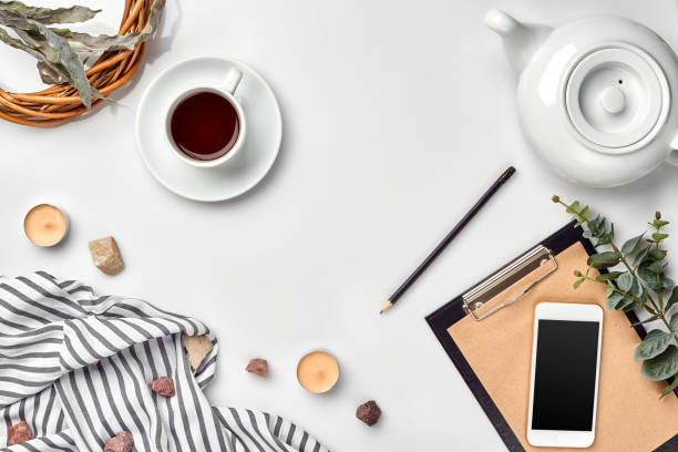 istock Notepad with pen and cup of tea on white table. Working space. Handmade. Top view, flat lay. 1094974440