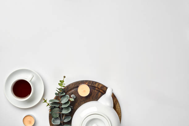 Top view of the tea pot and tea cup on white background