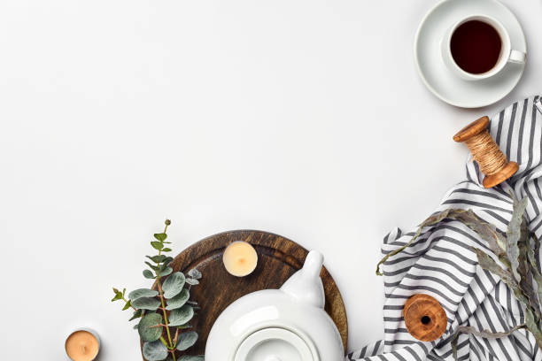 istock Still life with tea cup and the contents of a workspace composed. Different objects on white table. Flat lay 1094974470