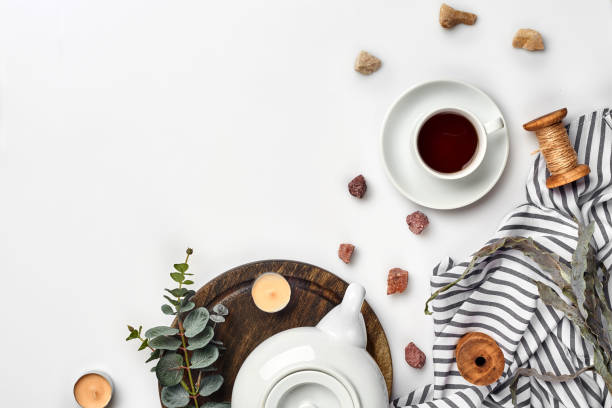 istock Still life with tea cup and the contents of a workspace composed. Different objects on white table. Flat lay 1094974484