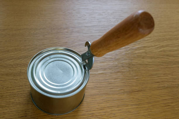 istock tin can with pate open on a wooden table with an opener 1094977420