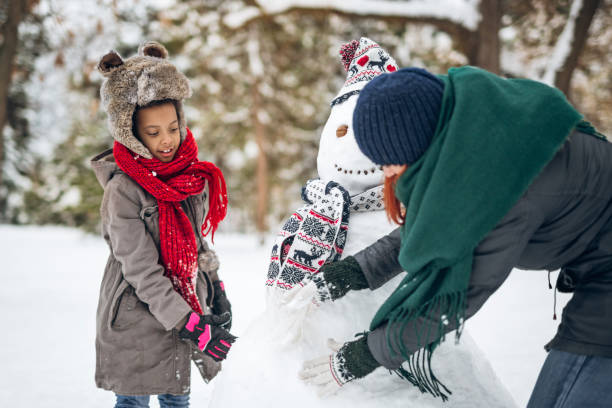 istock Making snowman with friends and family 1094978200