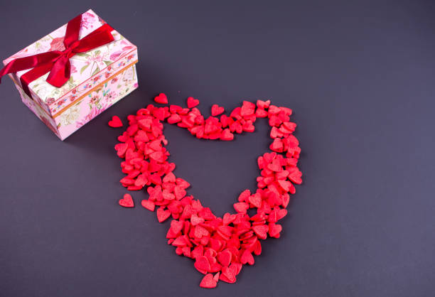 istock Symbol heart of candy sweets on black background. Top view. 1094979874