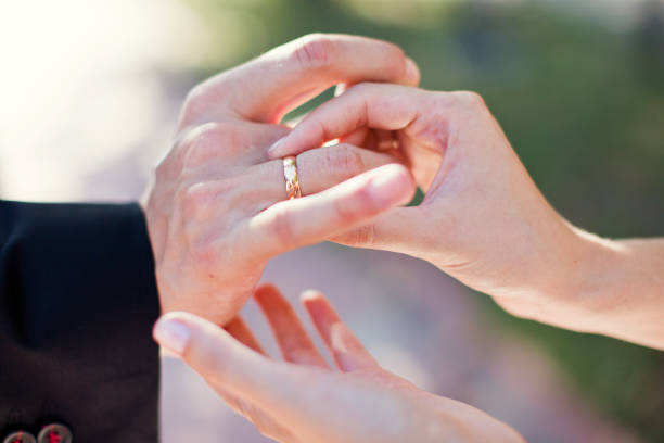 istock Bride and groom exchanging rings 1094980518