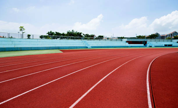 istock Red plastic running track in a playground 1094980606