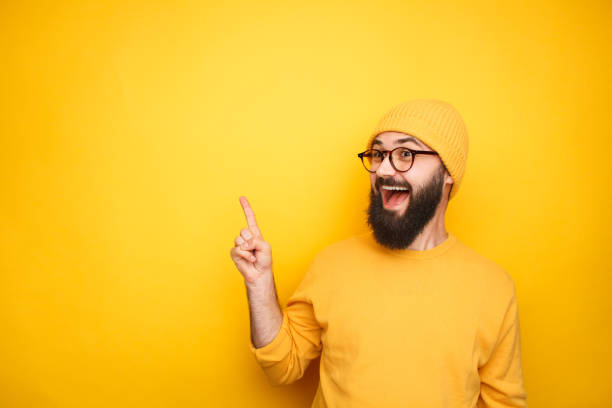 istock Excited hipster pointing up on yellow 1094980680