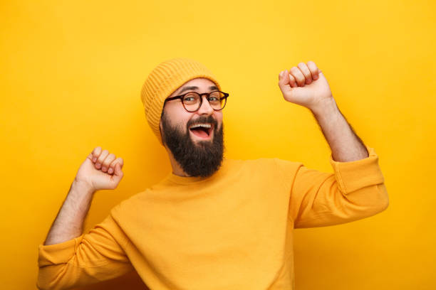 istock Cheerful hipster guy dancing on yellow 1094980692