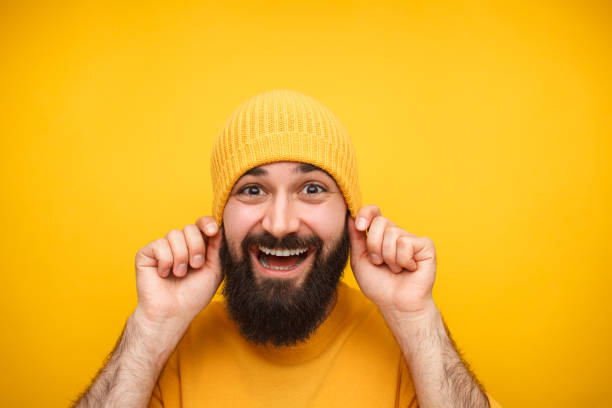 istock Cheerful man in yellow knitted hat 1094980710