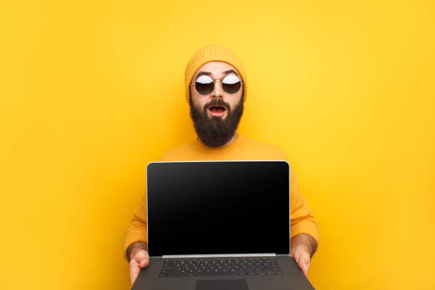 istock Trendy man advertising laptop 1094980712