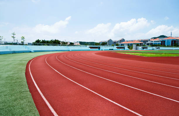 istock Red plastic running track in a playground 1094980778
