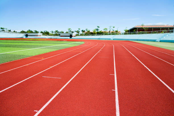 istock Red plastic running track in a playground 1094982148