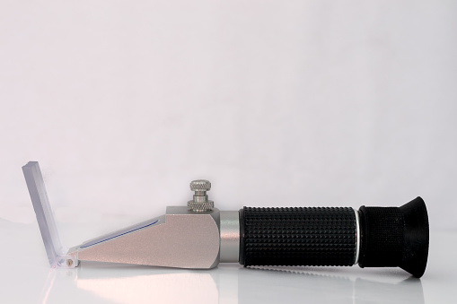 Black and silver refractometer isolated on white background