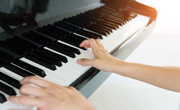 istock Woman hand playing the piano 1094983320