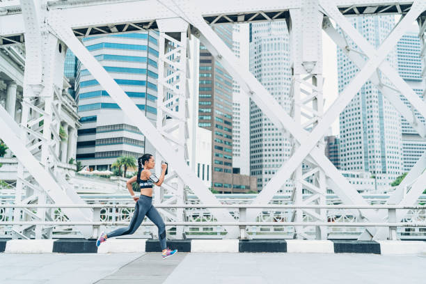 istock Female athlete running at cityscape background 1094987404
