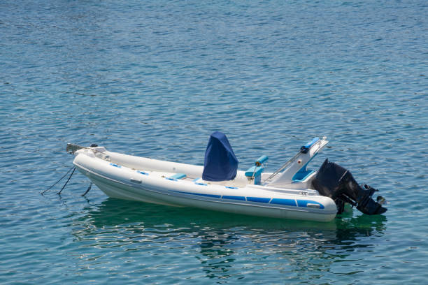 istock Small white blue motorized boat anchored on the shore. 1094990268
