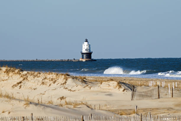 istock Beach with lighthouse in distance 1094990358