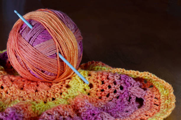 istock Crochet hook in warm colored yarn with copy space 1094990762