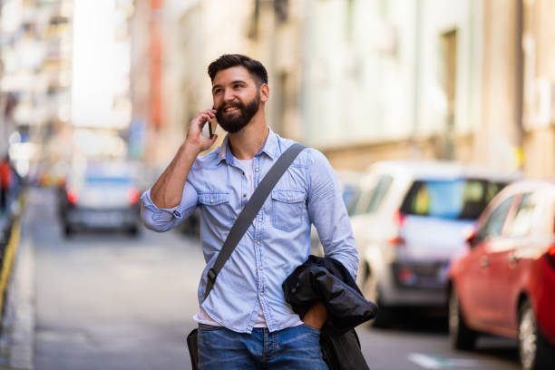 istock Smiling man using smart phone on the street 1094992502